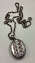 A heavy silver locket on fine link chain.