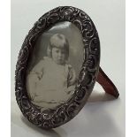 A small chased silver picture frame.