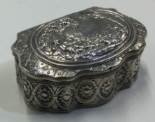 A late 19th Century silver snuff box with hinged lid embossed with scenes.