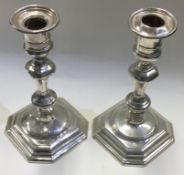 A pair of Edwardian silver candlesticks in the Georgian style.