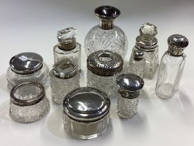 A collection of silver mounted scent bottles.