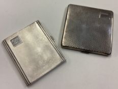 Two heavy silver cigarette cases.
