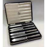 A cased set of six silver handled knives.