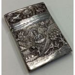 A heavy chased Indian silver card case with hinged lid.