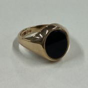 A gent's signet ring of typical form in 9 carat mount.