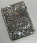 A heavy chased silver double-sided castle top card case depicting horses and carriage.