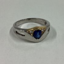 A sapphire and diamond three stone ring in 18 carat gold setting.