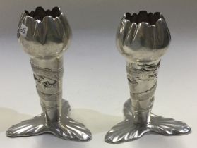 A rare pair of Chinese export silver vases embossed with dragons.