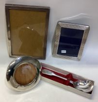 Three silver picture frames together with a salt shovel.