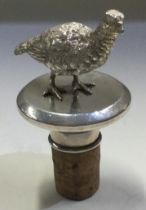 A heavy cast silver grouse bottle stopper. London 1977.