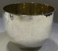 A large hammered silver tumbler cup with gilt interior.