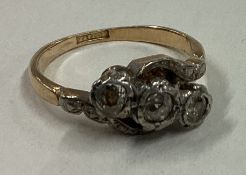 A diamond three stone ring in 18 carat gold setting.