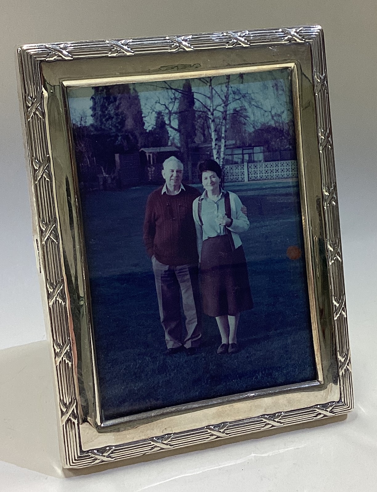 A decorative silver picture frame with gadroon border.