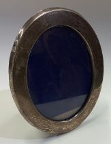 A large oval silver picture frame.