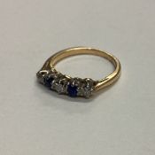 A sapphire and diamond five stone half hoop ring in 18 carat gold mount.