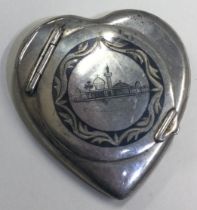 A heart shaped Persian silver and Niello compact.
