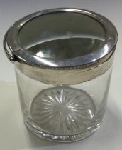 A large silver and glass swing handled dressing table jar.