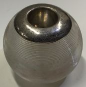 A large silver and glass match striker.