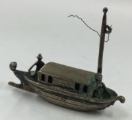 An Antique silver toy model of a sailing boat.