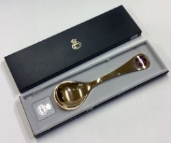 GEORG JENSEN: A cased silver gilt spoon.