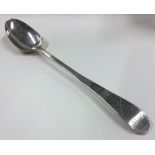 A large silver basting spoon with bright-cut decoration to handle.