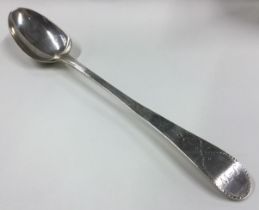 A large silver basting spoon with bright-cut decoration to handle.