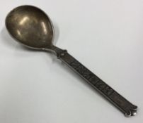 An Antique Art Nouveau silver spoon with chased decoration.