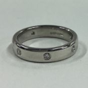 A good diamond seven stone eternity ring in platinum rub over mount.