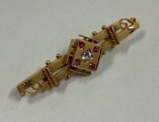 An attractive Victorian ruby and diamond brooch in 15 carat gold mount.