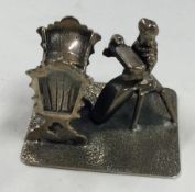 An Antique Dutch silver toy figure of a woman holding a baby.