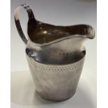 A Georgian silver cream jug with bright-cut decoration. London 1801.