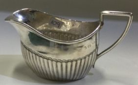 A fluted Victorian silver cream jug. Birmingham.