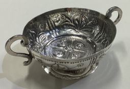 A rare early 17th Century silver wine taster / porringer on foot.