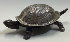 A large silver bell in the form of a tortoise.