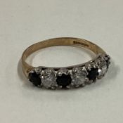 A small sapphire mounted half eternity ring in 9 carat setting.