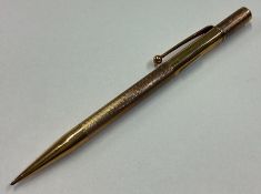 A heavy 9 carat engine turned pencil.