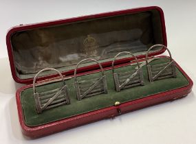 A rare cased set of four silver menu holders in the form of five bar gates.