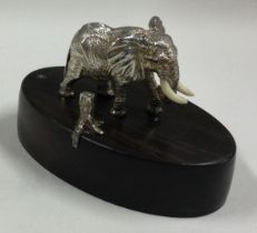 PATRICK MAVROS: A silver menu / place card holder cast with elephant.
