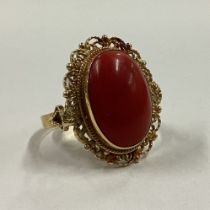 A large oval coral ring in 18 carat gold mount.