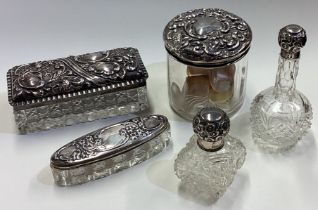 A collection of silver mounted scent bottles.