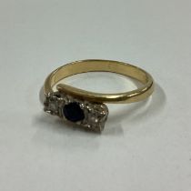 A diamond and sapphire three stone ring in 18 carat gold mount.