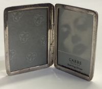 A small silver travelling picture frame.