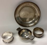 A small silver bowl together with napkin rings etc.