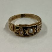 An enamel and pearl mourning ring in 15 carat gold mount.