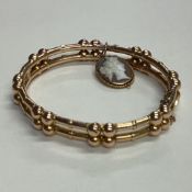 A 9 carat hinged bracelet with concealed clasp.
