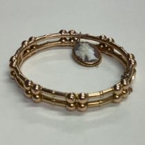 A 9 carat hinged bracelet with concealed clasp.