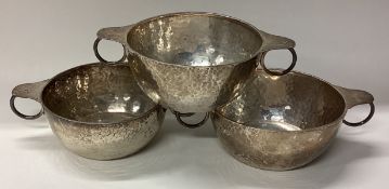 A good set of three tapering silver bowls of textured form.