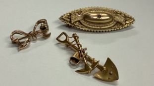 A group of gold brooches.