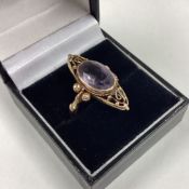 A small amethyst ring of stylised form.