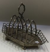 A rare novelty silver toast rack on stand. London 1904. By Peter Henderson Deere.